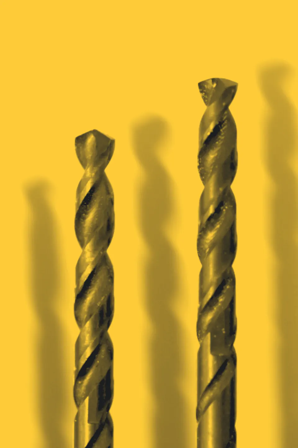 Two drill bits standing upright