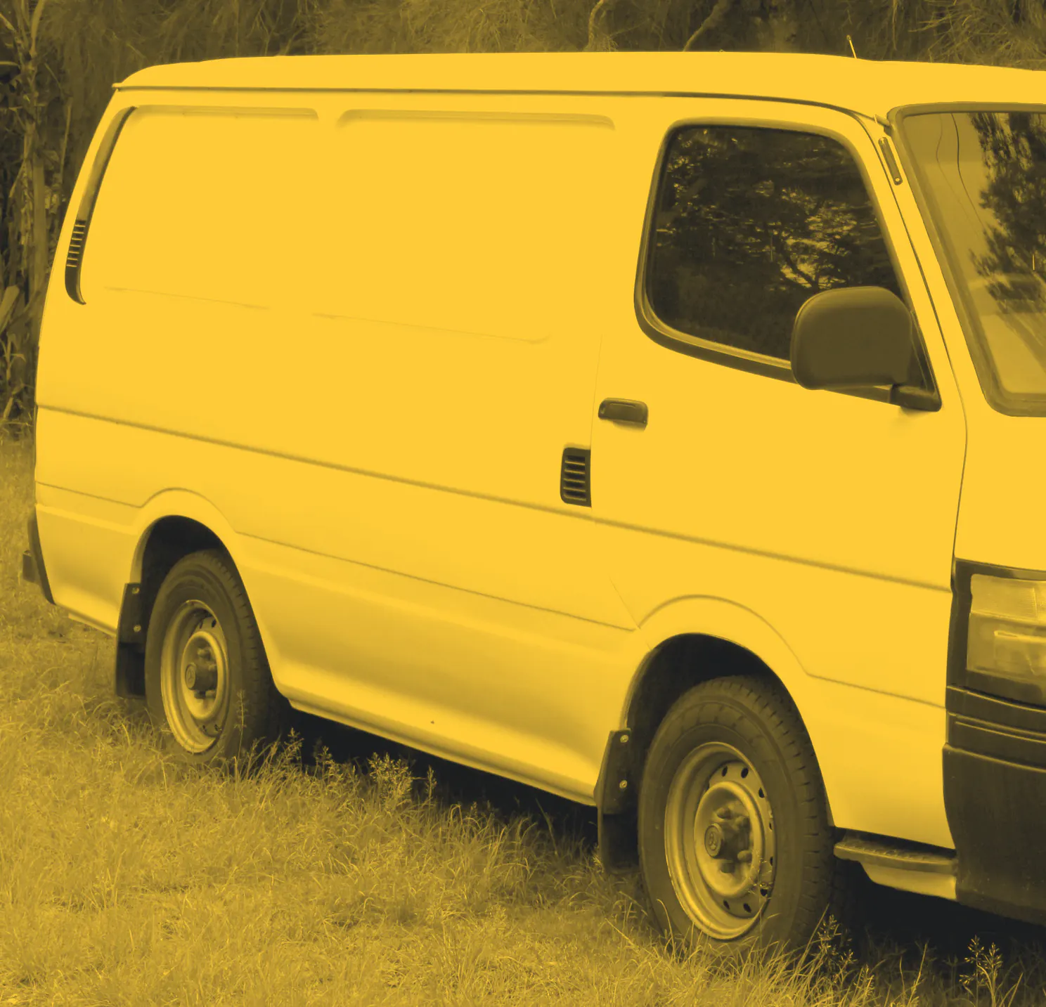 A plain white panel van parked on grass