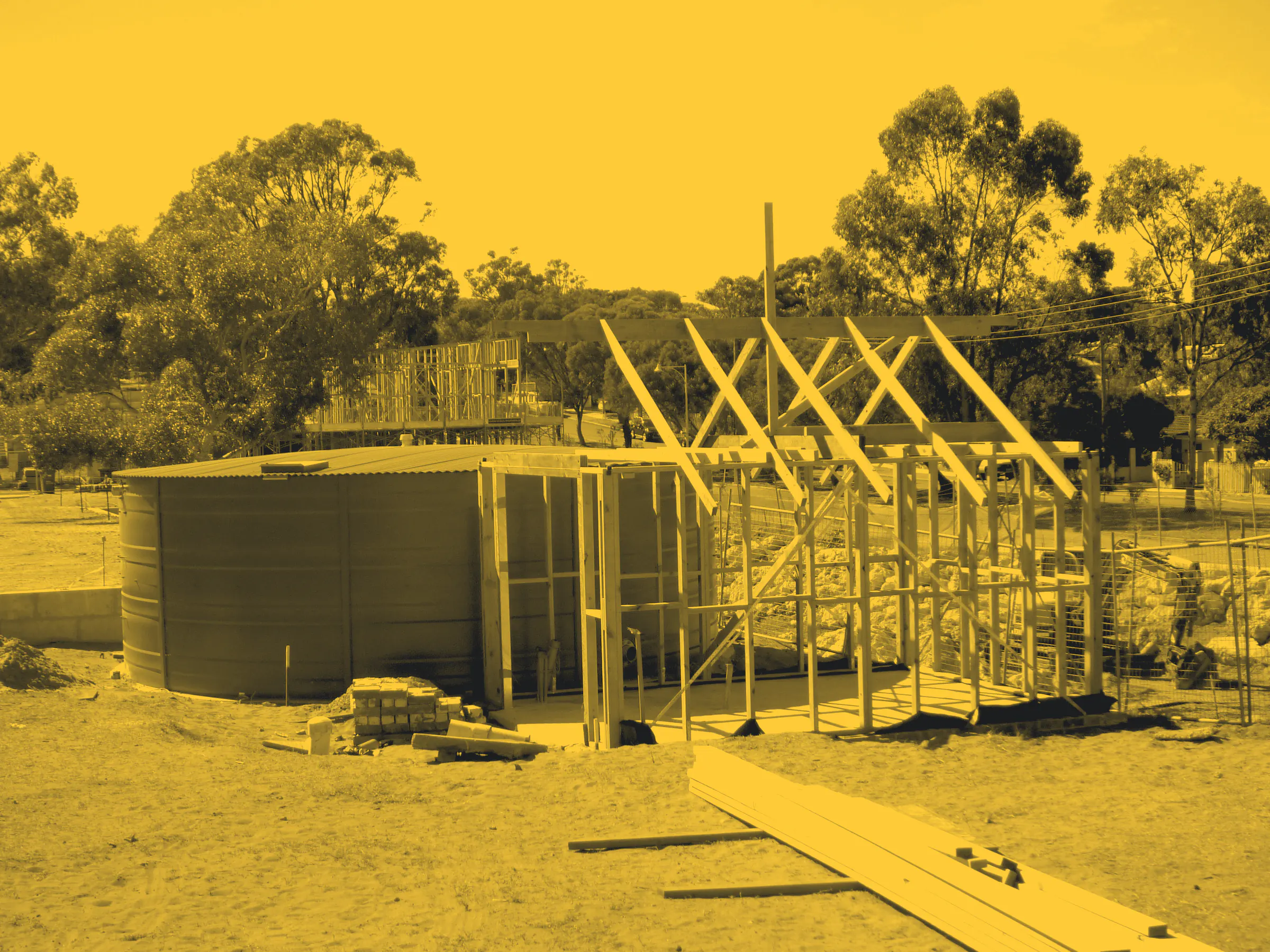 A timber framed building under construction among gum trees in White Gum Valley, Fremantle